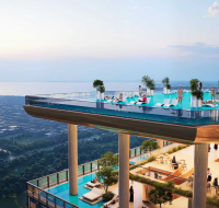 The complete waterfront residential skyline developed by Sobha Realty, with the central circular landmark reflected in the water.