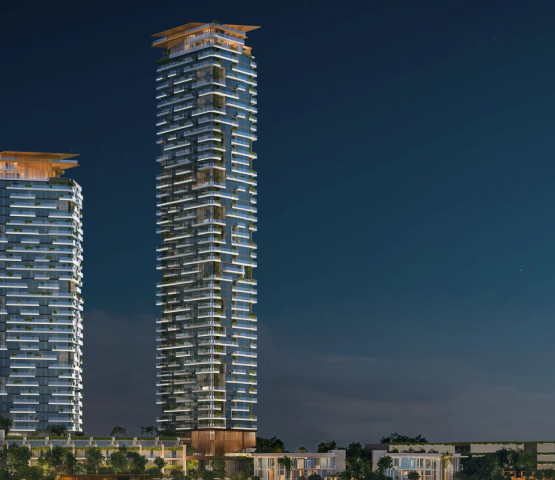 Night view of the two gleaming Soulever by Beyond towers, a luxury residential project in Dubai Maritime City.