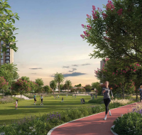 Lush community green space with flowering trees, a dedicated running path, and apartment buildings in the background.