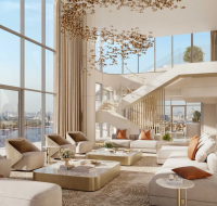 Outdoor communal terrace featuring a living green wall, modern seating, and people conducting casual business meetings.