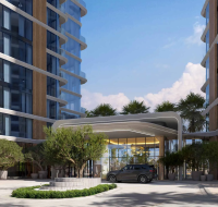 Cluster of three contemporary high-rise towers with a sculptural, faceted design next to a waterway.