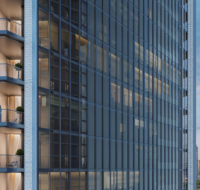 Triple-height entrance lobby with marble flooring and artistic decor