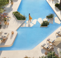 Luxury swimming pool with sunbeds and greenery