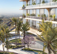 Modern residential building with glass balconies surrounded by palm trees and lush landscaping