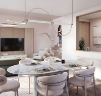 Elegant open-plan dining and living area with modern interiors and kitchen pass-through at WAADA